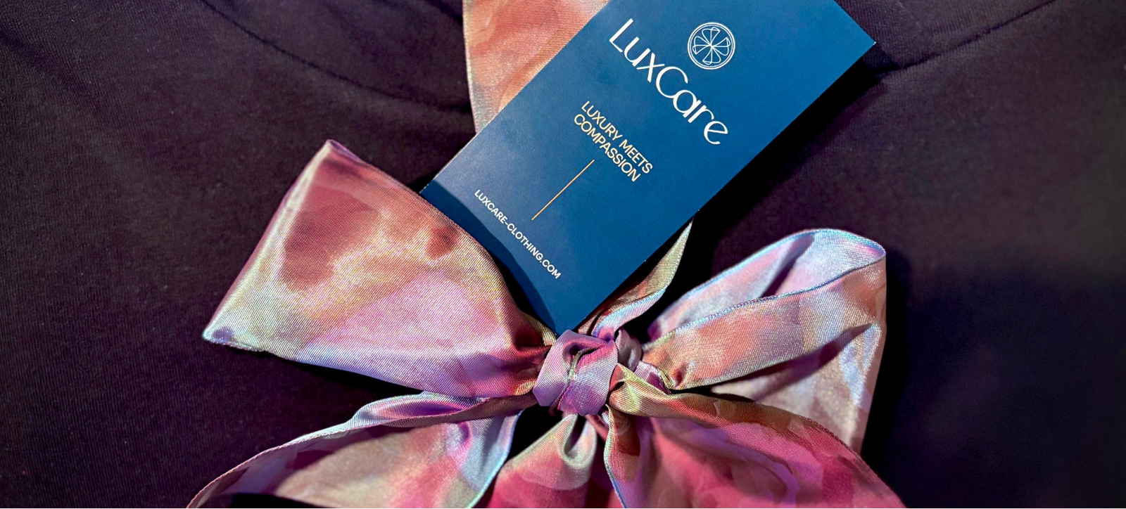 LuxCare label on a garment with a colorful bow