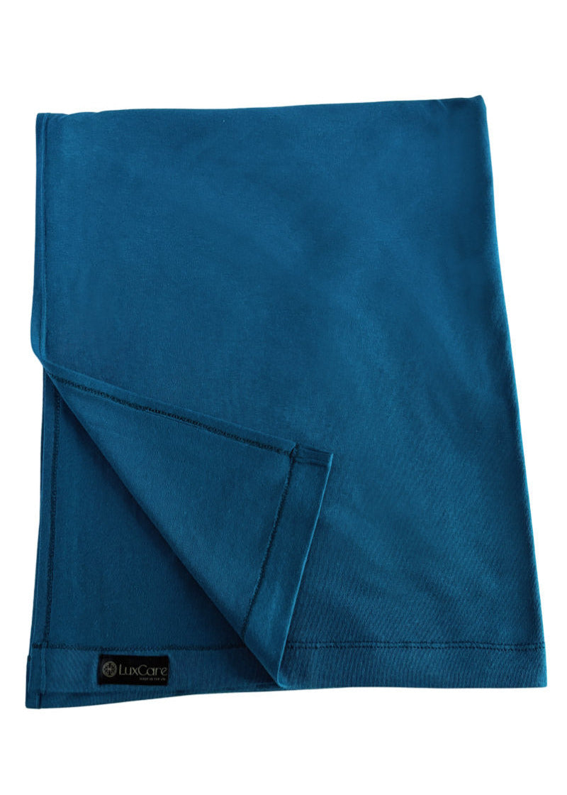 Blue Travel Shawl with a brand label on a white background
