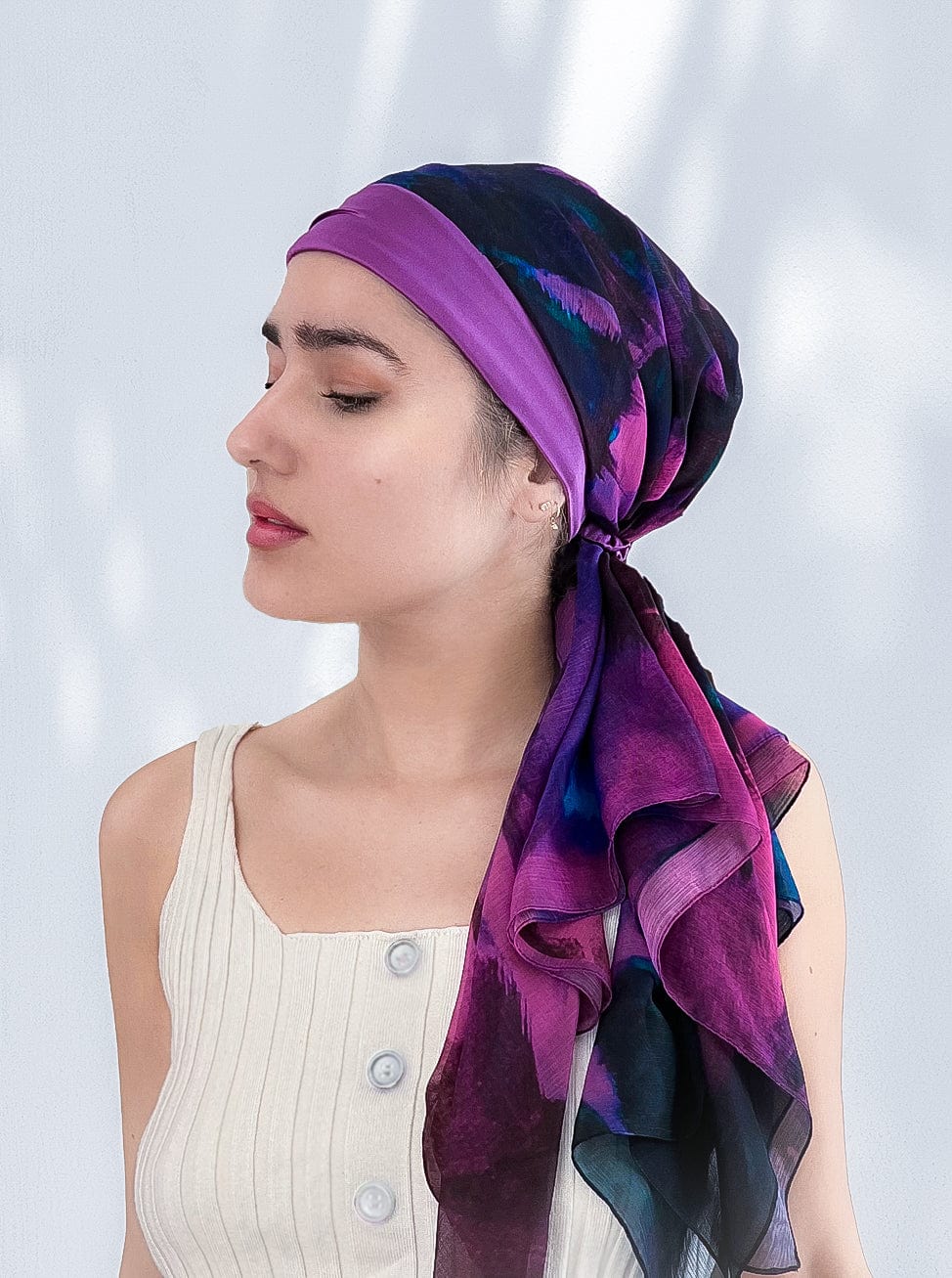 Fashionable woman in medically accessible adaptive clothing head scarf.