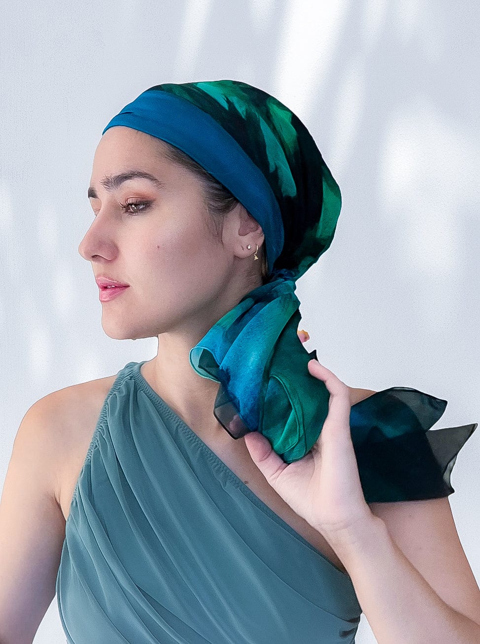 Fashionable woman in medically accessible adaptive clothing head scarf.