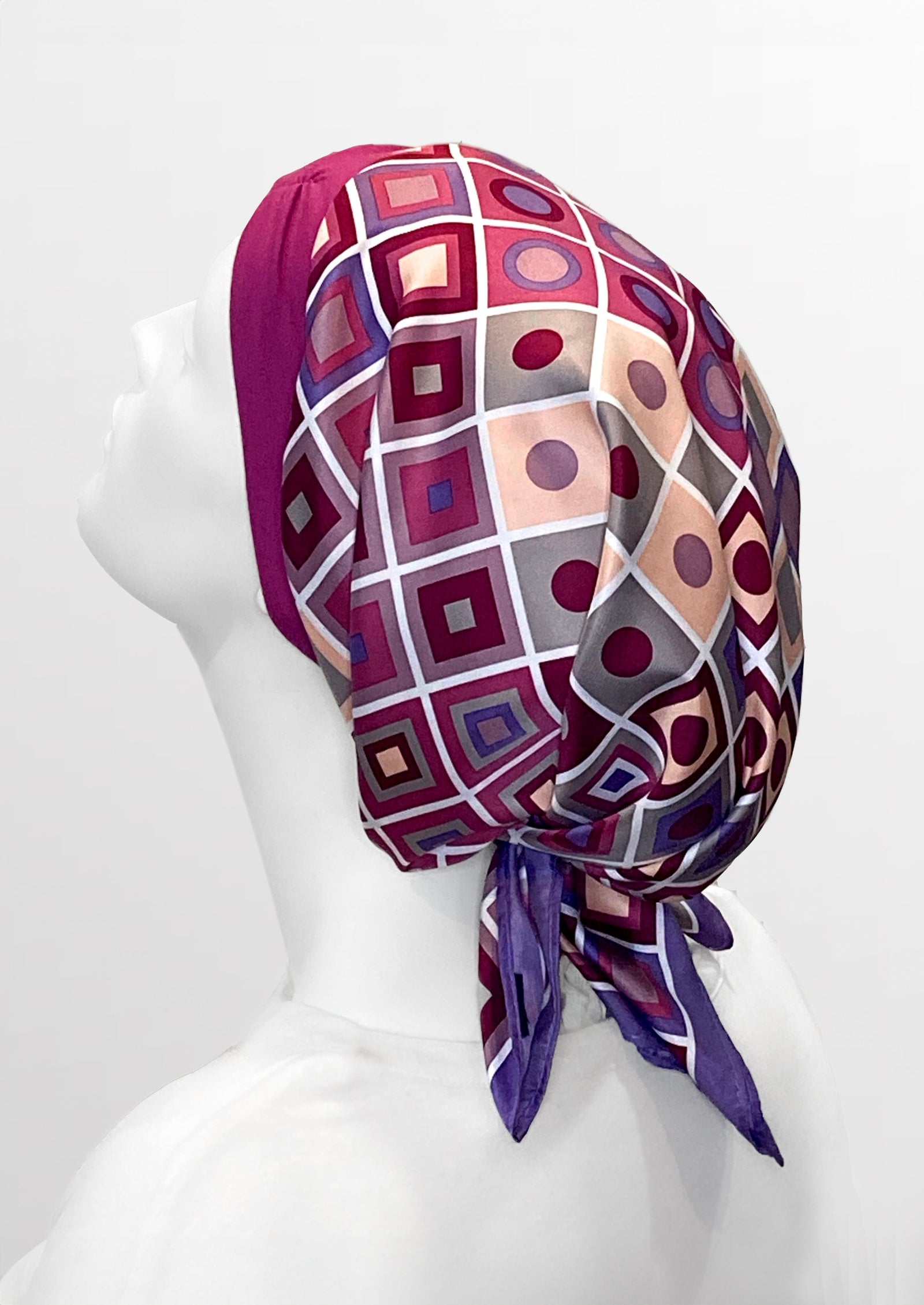 Fashionable headscarf, of pink and lavender with geometric shapes , in the retro kerchief style, designed specifically for those experiencing hair loss