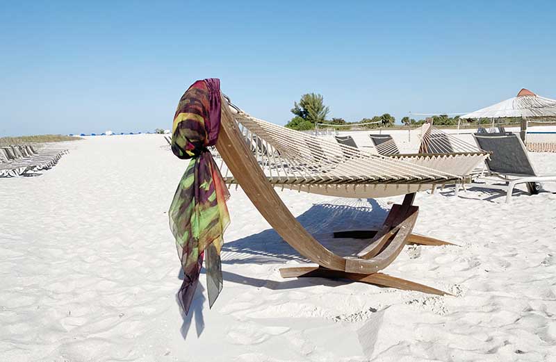 fashionable headscarf for hair loss hanging on a beach chair