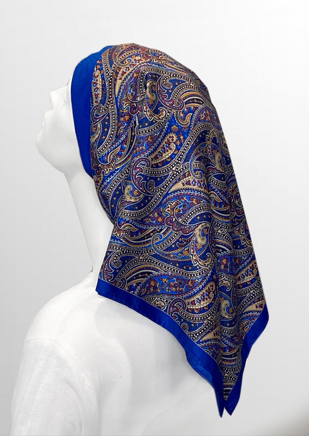 Beautiful woman wearing a blue paisley headscarf designed specifically for those dealing with hair loss