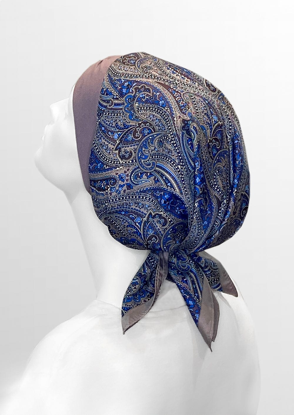 beautiful woman wearing a fashionable headscarf, of lavender and paisley, in the retro kerchief style, designed specifically for those experiencing hair loss
