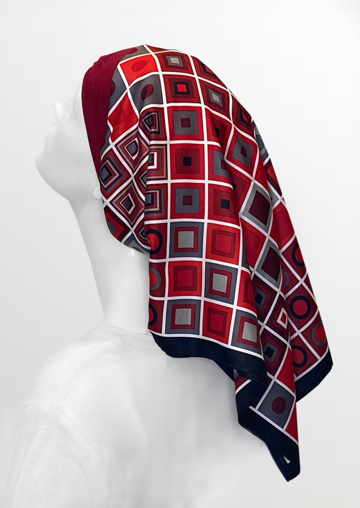 Fashionable headscarf, of ruby red and black with geometric shapes , in the retro kerchief style, designed specifically for those experiencing hair loss.