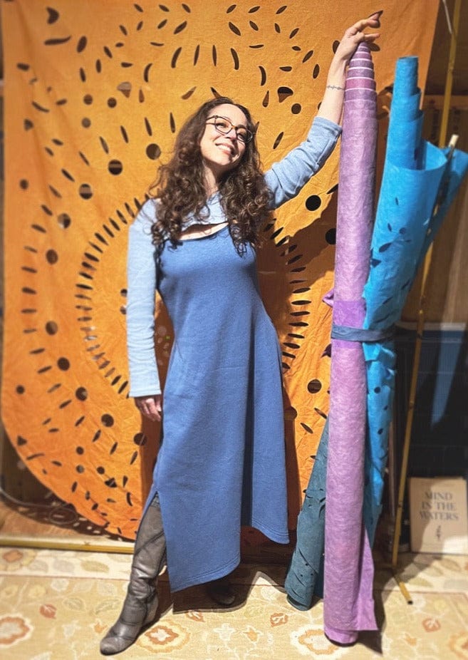 Woman is a cozy stylish dress that is chest port accessible for infusions. 