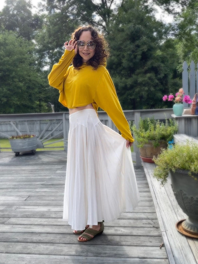 Woman in golden cute cropped sun safe upf 50+ hoodie for travel , with extra large hood and glovelettes for hand protection