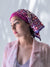 Fashionable woman in medically accessible adaptive clothing head scarf.