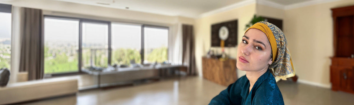 luxcare headscarf golden paisley on beautiful woman in a large apartment